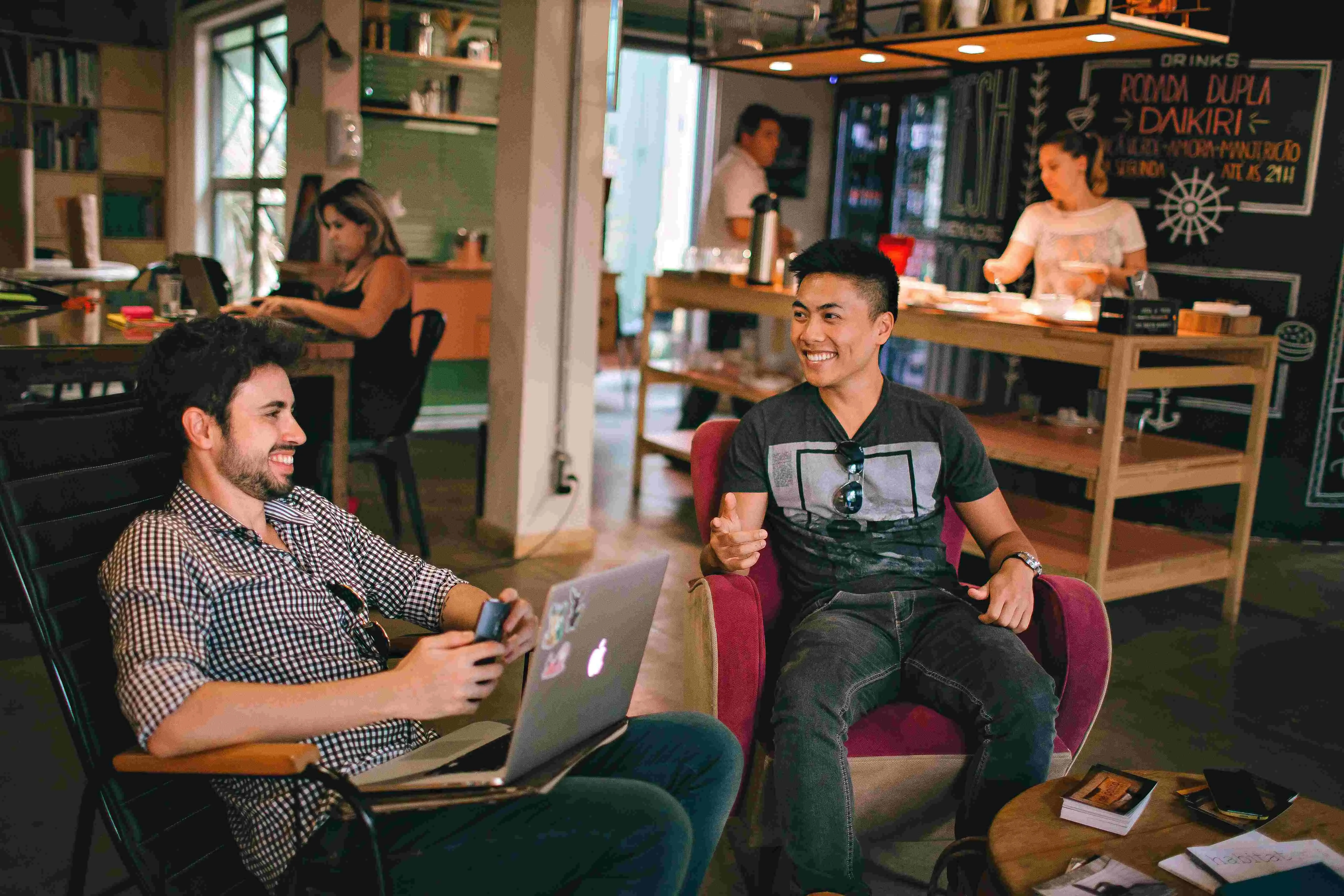 Two colleagues discussing work in a coffee shop