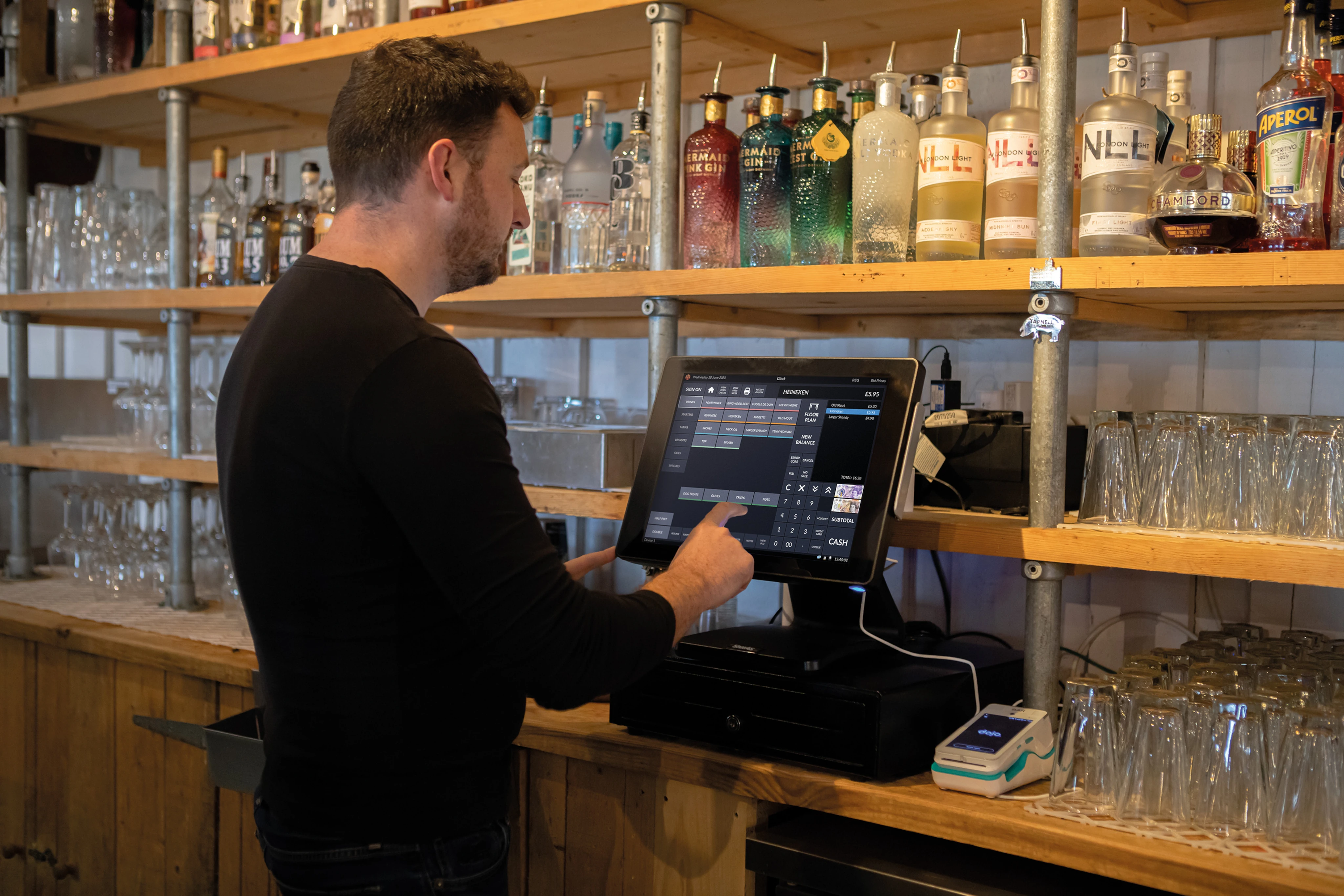A close up of a digital tablet POS being interacted with